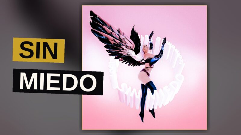 A stylized image of a singer surrounded by neon lights and a glowing moon, evoking a dreamy Latin pop album mood.