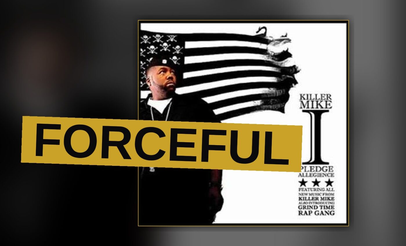 A rapper stands under bright light, his face tense and determined.