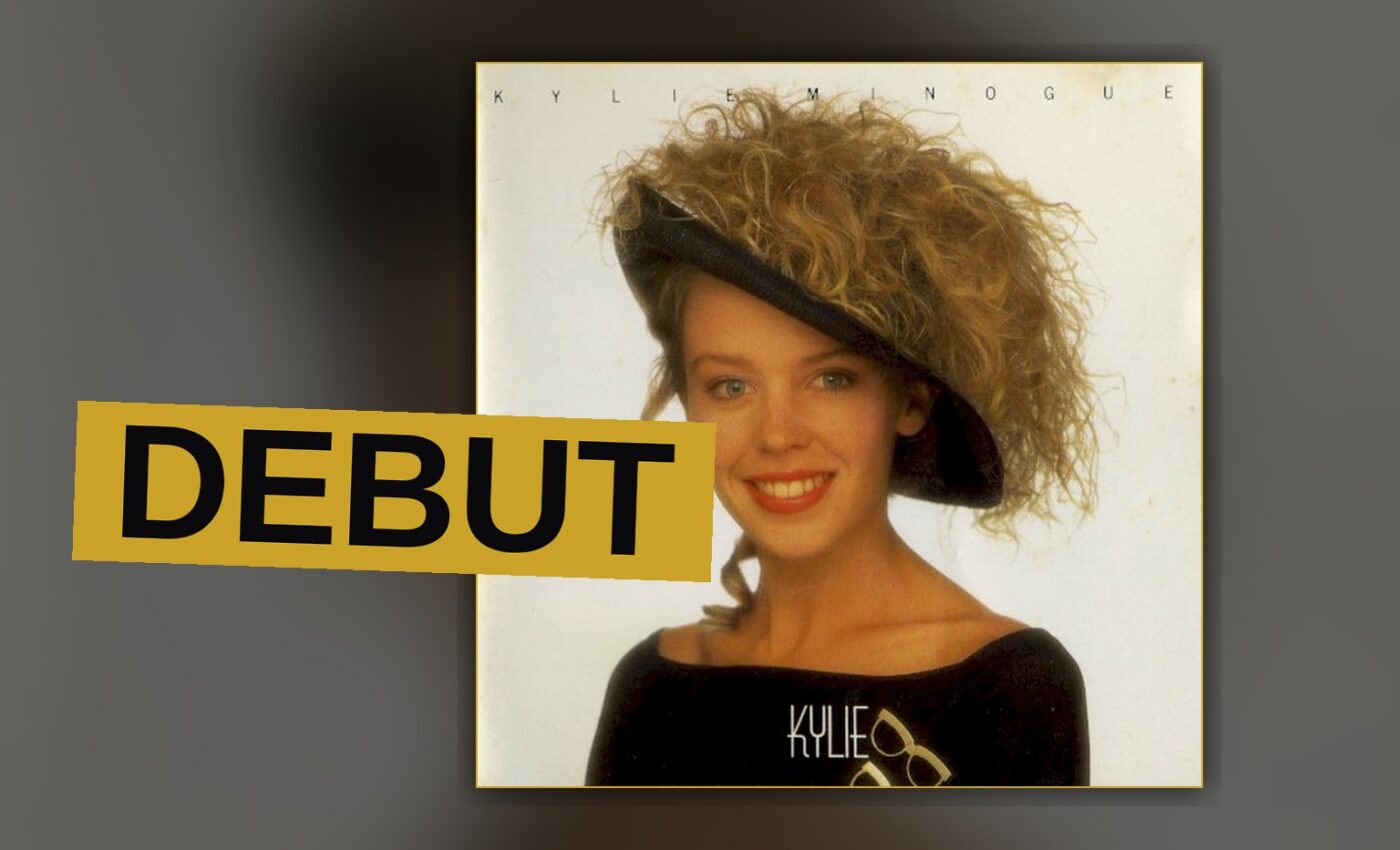 A young singer stands amid bright lights, recalling the record's bright, radio-friendly sound.