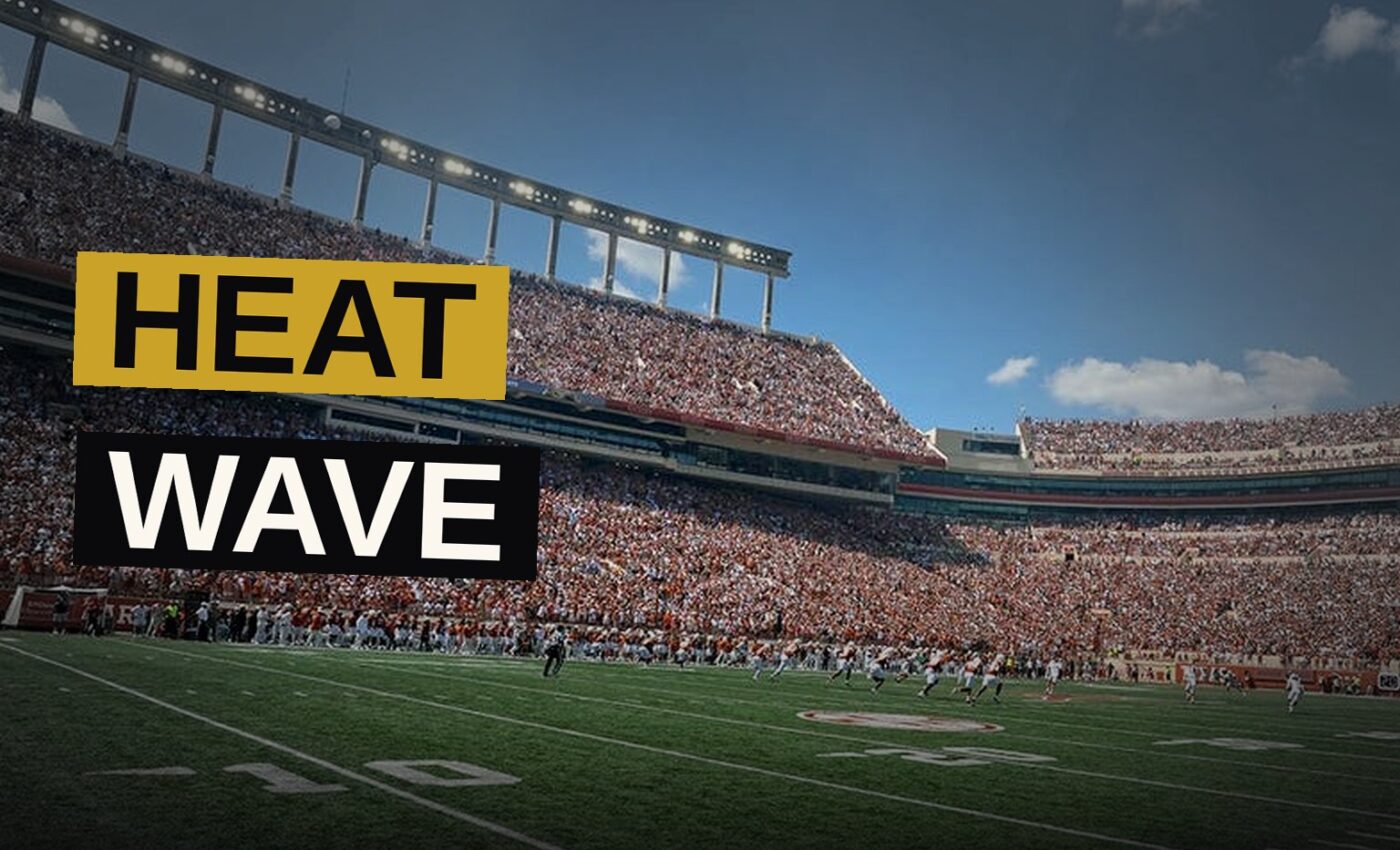 A multitude of spectators gather beneath a merciless sun, seeking shadow from the fierce and burning heat of the stadium passage.