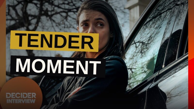 A lioness character embraces her partner inside a helicopter, conveying warmth amid a tense situation.