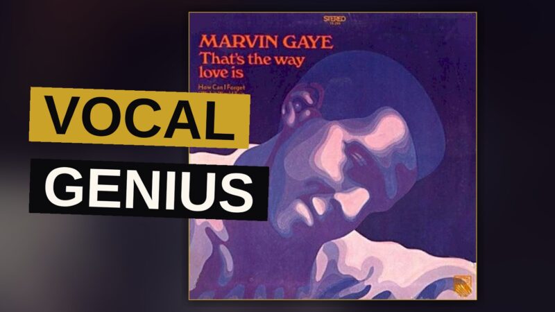 A soulful man in a dark turtleneck sings into a vintage microphone under warm amber lighting, with a pained, passionate expression.