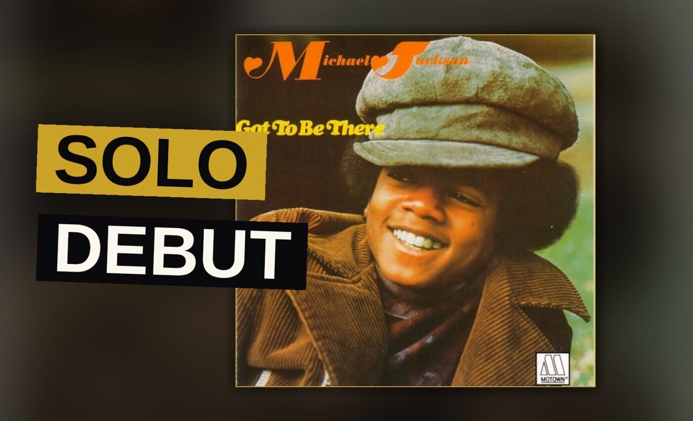 A young Michael Jackson with an afro sings into a retro microphone in a warm, sepia-toned 1970s studio setting.