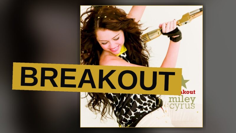 A singer performs under bright stage lighting, conveying energy and youthful ambition.