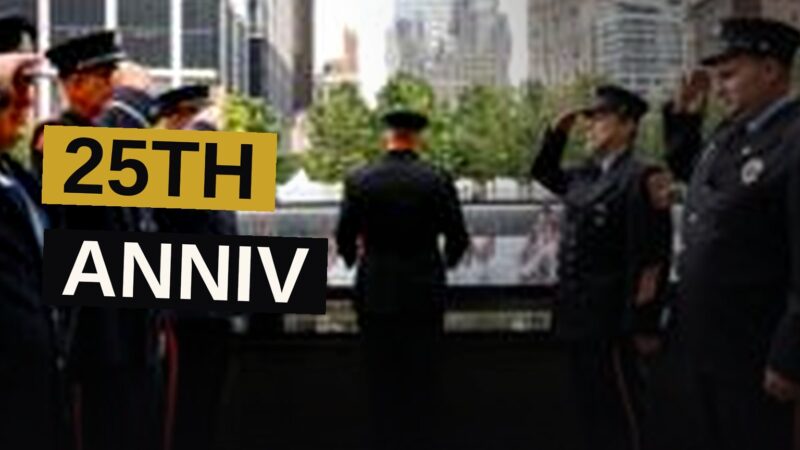 A memorial at Ground Zero with a steel column and American flags, marking the anniversary of the 9/11 attacks.