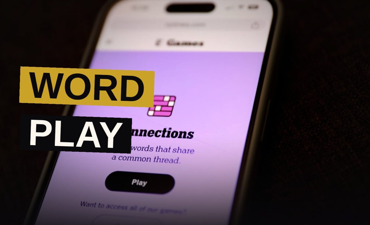 A smartphone displaying a word puzzle grid, surrounded by paper cards with word definitions.