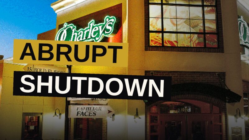 A closed O'Charley's restaurant at dusk with a 'closed' sign in the window and an empty parking lot.
