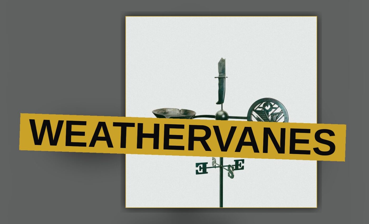 A weathervane sits atop a rustic barn under a darkening, storm-streaked sky.