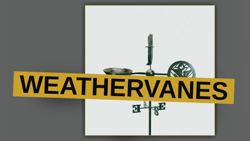A weathervane sits atop a rustic barn under a darkening, storm-streaked sky.