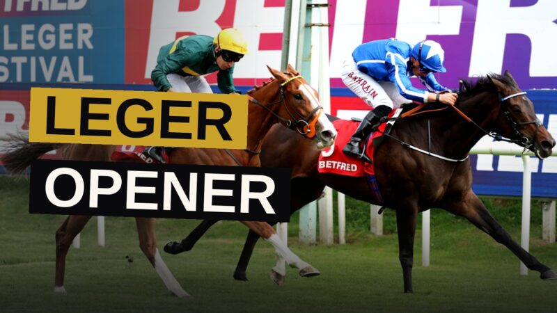 Horse racing at Doncaster with horses and riders competing on the turf in front of the stands.