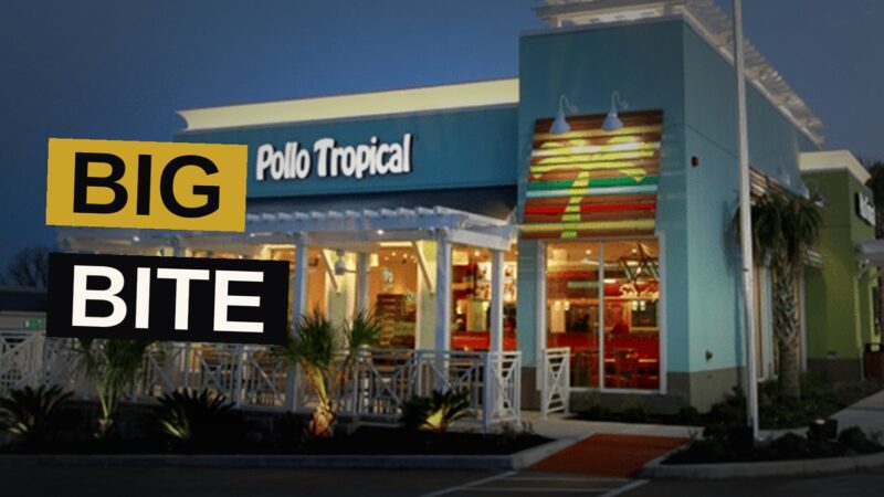 A Pollo Tropical restaurant at dusk with glowing signage and palm trees, suggesting expansion.
