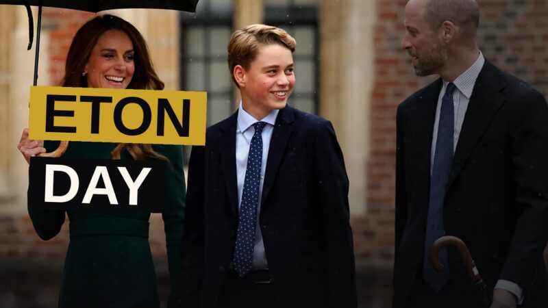 Prince George in his Eton College uniform, leaning against a stone pillar in the schoolyard.