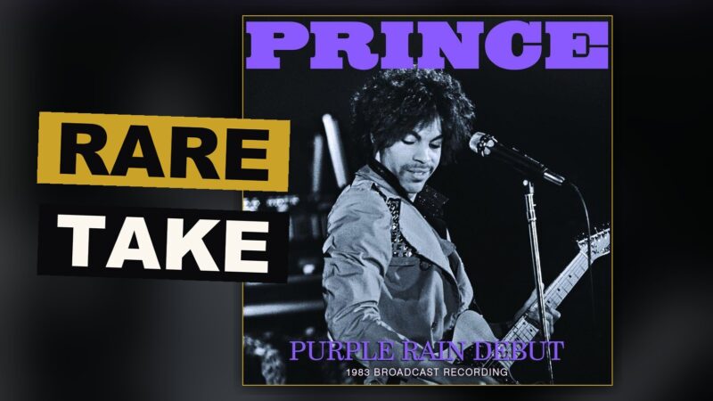 A guitar rests under dim purple light upon an empty stage, as though the band has only just stepped away.