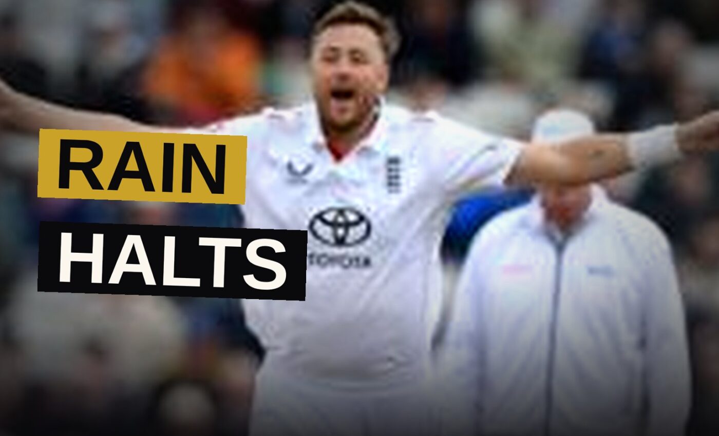 Cricket players walk off the field as rain falls and covers are placed on the pitch at Edgbaston.
