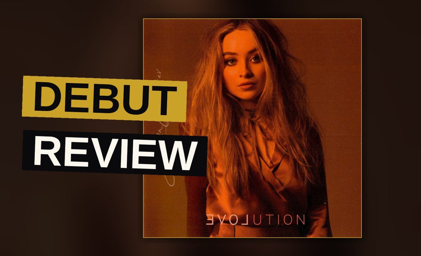 A young pop singer performs under dramatic stage lighting.