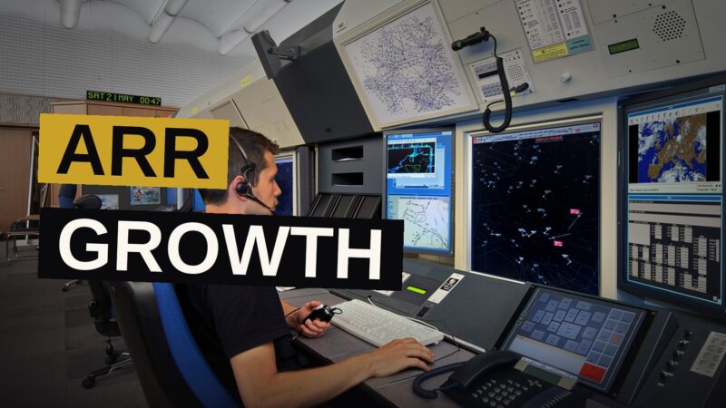 A digital dashboard displaying ARR metrics glows in a modern data center.