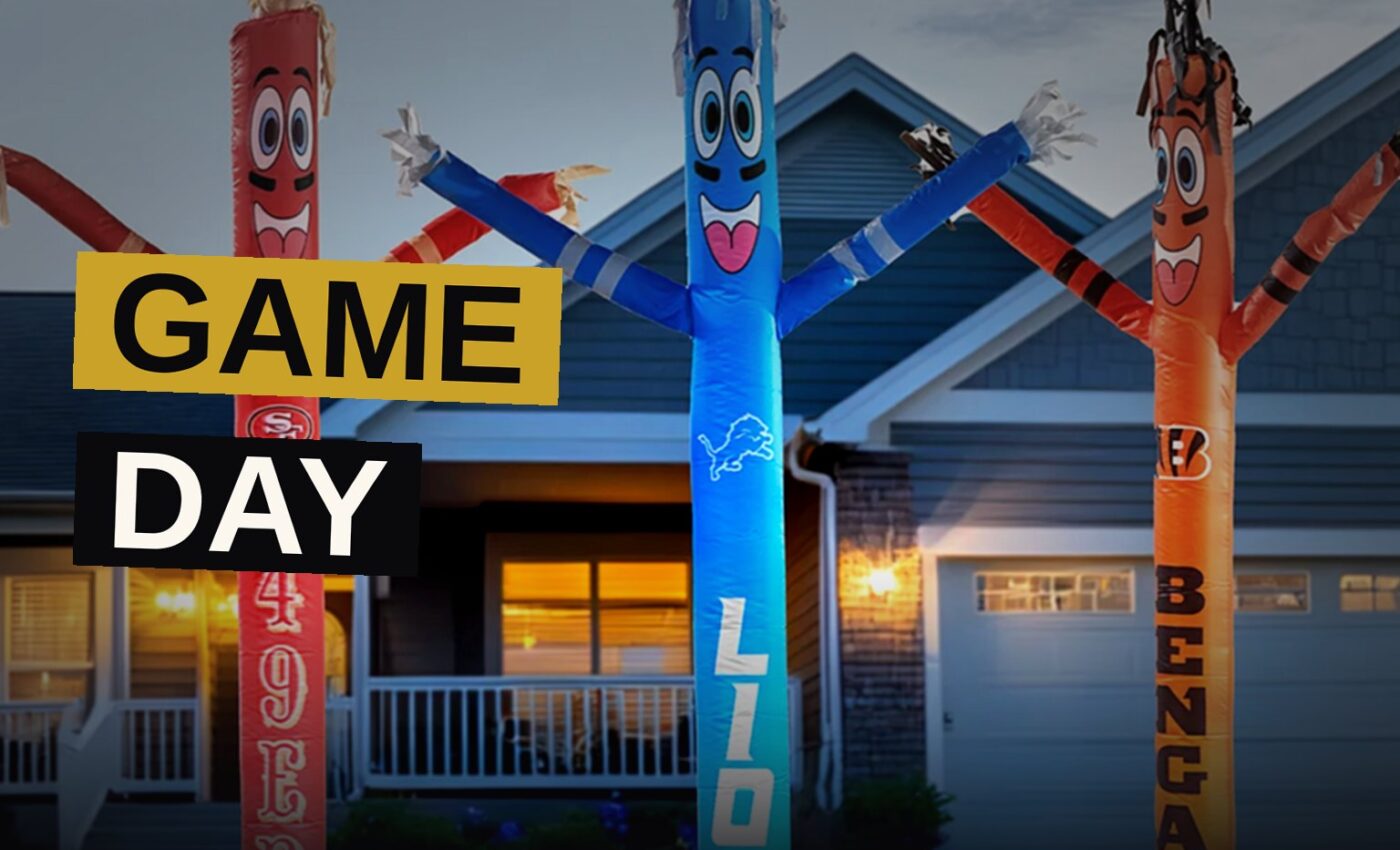A cozy living room decorated for an NFL watch party, featuring team gear, a snack platter, and bean bag seating.