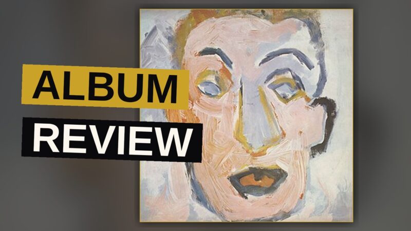 A vinyl record sleeve with a blurred portrait of Bob Dylan in warm amber tones.