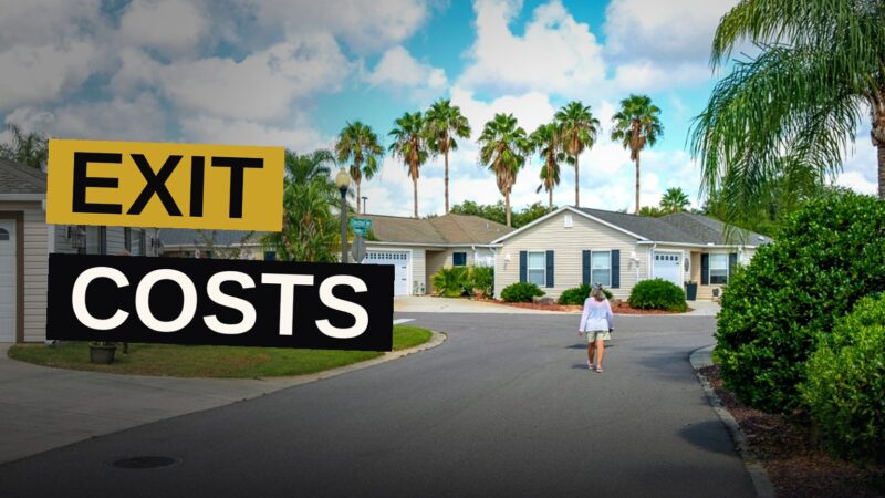 A Florida retirement community with a for-sale sign in front of a villa, golf carts nearby.