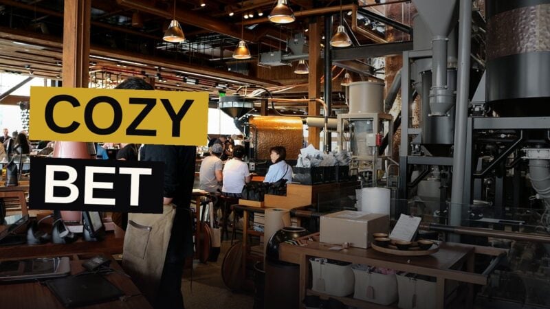 A cozy Starbucks store with leather chairs, a fireplace, and bookshelves.