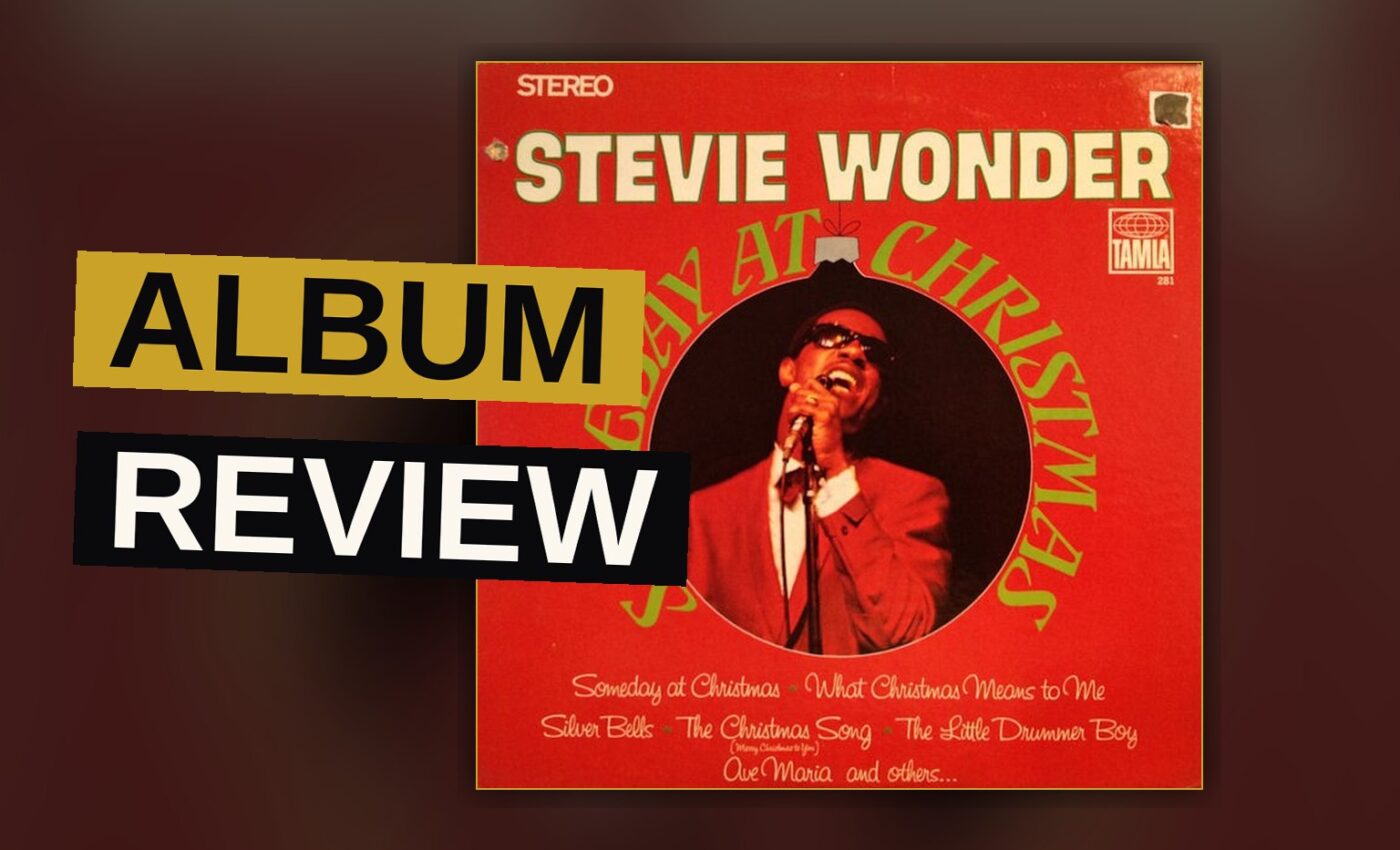 A vintage Christmas album cover with a young Stevie Wonder in a festive sweater, lit warmly in a studio.