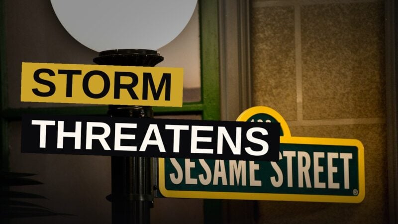 A wet Sesame Street street with a glowing sign beneath storm clouds, symbolizing the show's peril.