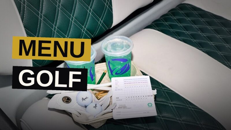 A whimsical golf course scene featuring a Taco Bell drive-thru on the fairway and a taco-shaped golf tee.