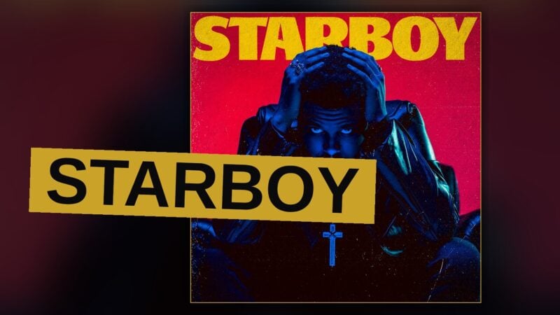 A pop star stands under a glowing star-shaped light on a dark stage.