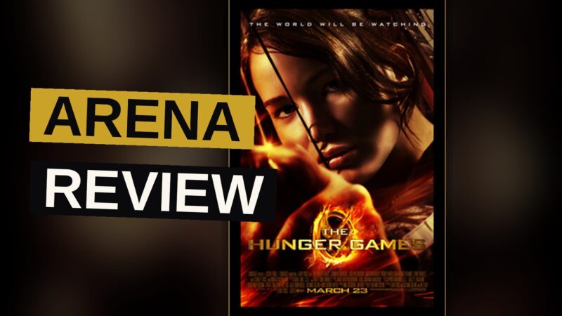 Jennifer Lawrence as Katniss Everdeen aiming a bow and arrow in a dark forest.