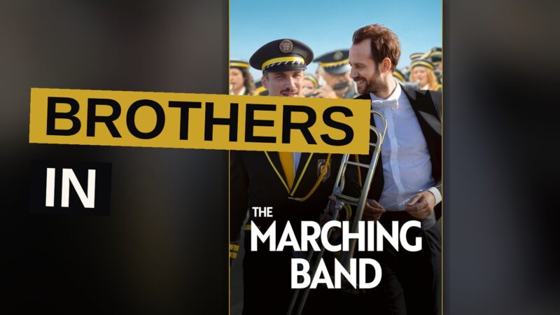 A conductor and a horn player stand together upon a stage, brothers bound by music neither expected to share.