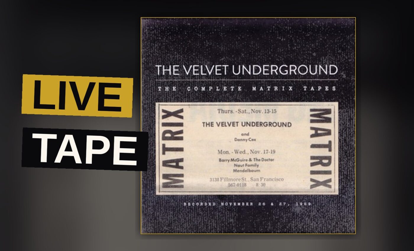 A dimly lit stage with a vintage amplifier and scattered chairs, evoking a live rock concert atmosphere.