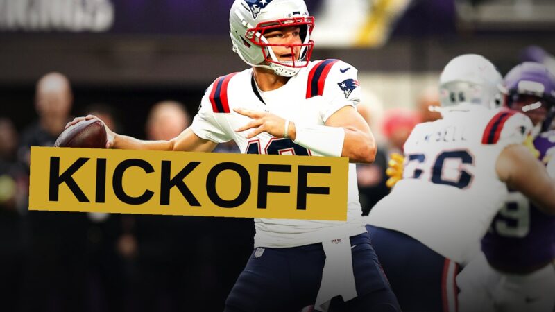 Two NFL teams face off on a brightly lit field at night in a packed stadium.