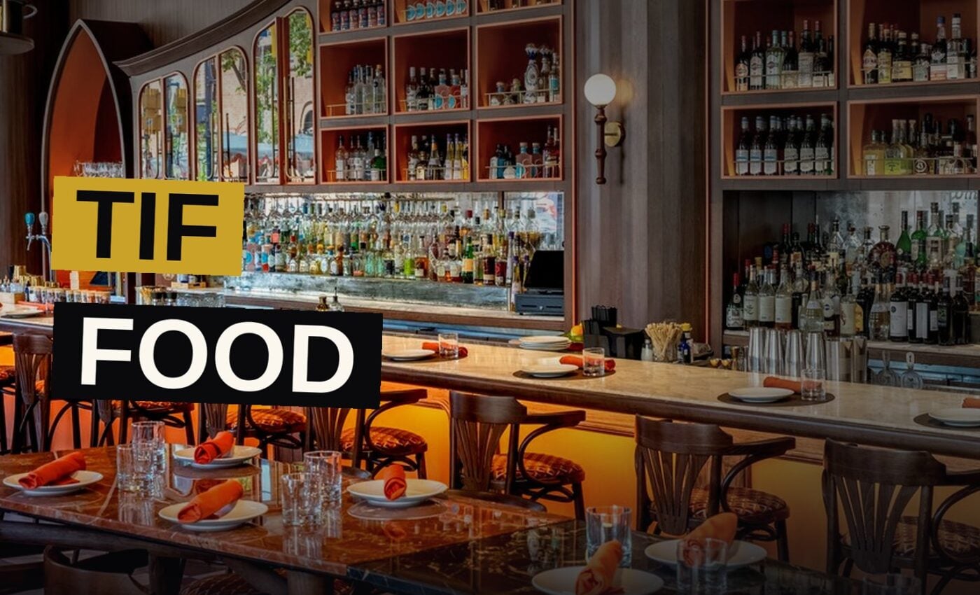 A lavish spread of dishes and cocktails in a stylish Toronto restaurant.