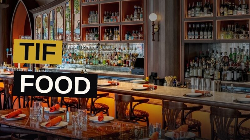 A lavish spread of dishes and cocktails in a stylish Toronto restaurant.