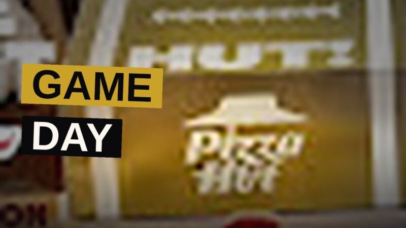 A football-themed Pizza Hut box with pull-out drawers open, showing two pizzas, breadsticks, and cinnamon sticks.