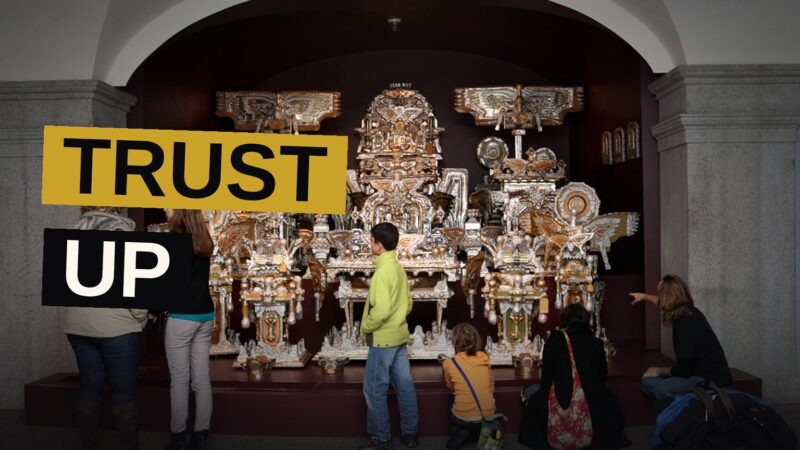 Illustration of a museum with an upward arrow and diverse people, symbolizing growing trust.