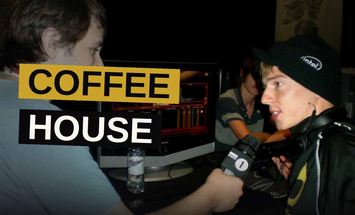 A pair of workers pour coffee within a warm, quiet cafe.