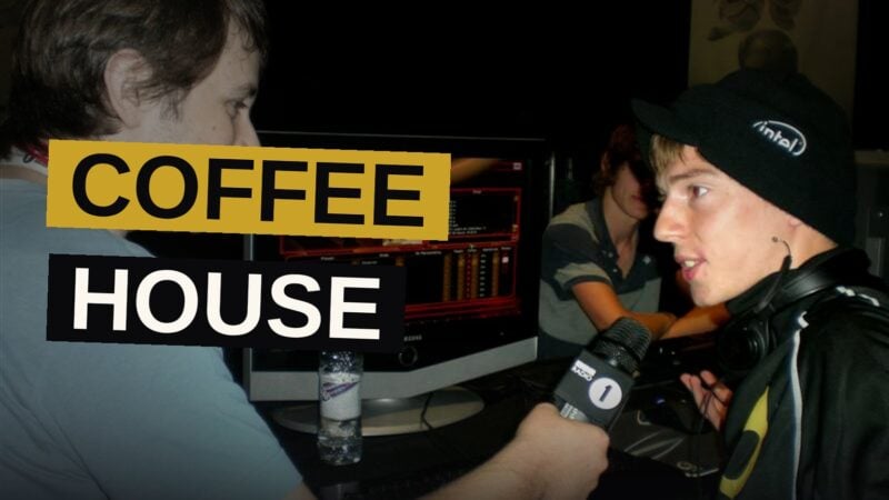 A pair of workers pour coffee within a warm, quiet cafe.