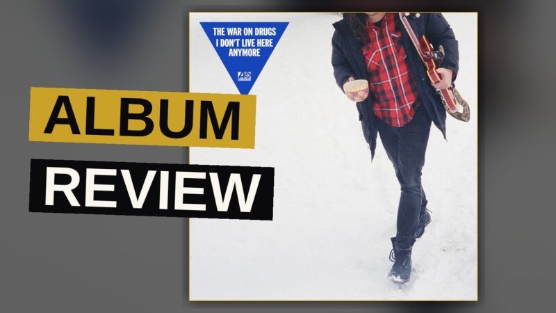 A vinyl record spins under warm light, evoking the mood of a reflective album.