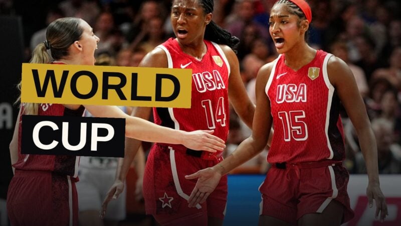 A Team USA basketball player drives past a Hungary defender during a fast-paced game in a packed arena.