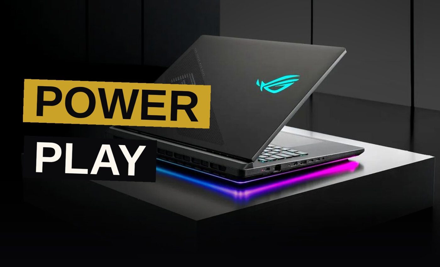 A high-end ASUS ROG gaming laptop with an illuminated keyboard and a vibrant 4K display on a dark desk.