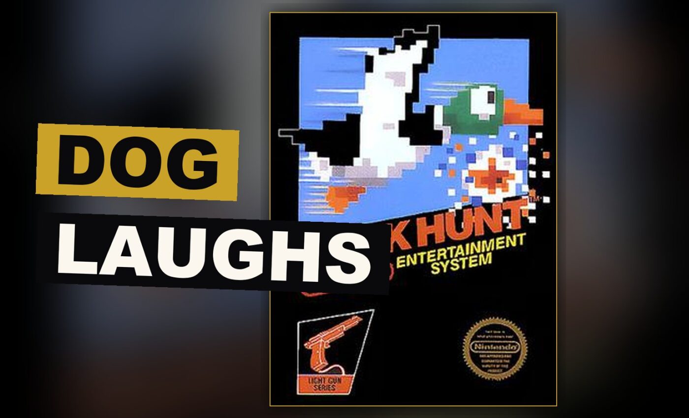 A gray dog rises from the grass holding a duck while a plastic gun rests before an old television.