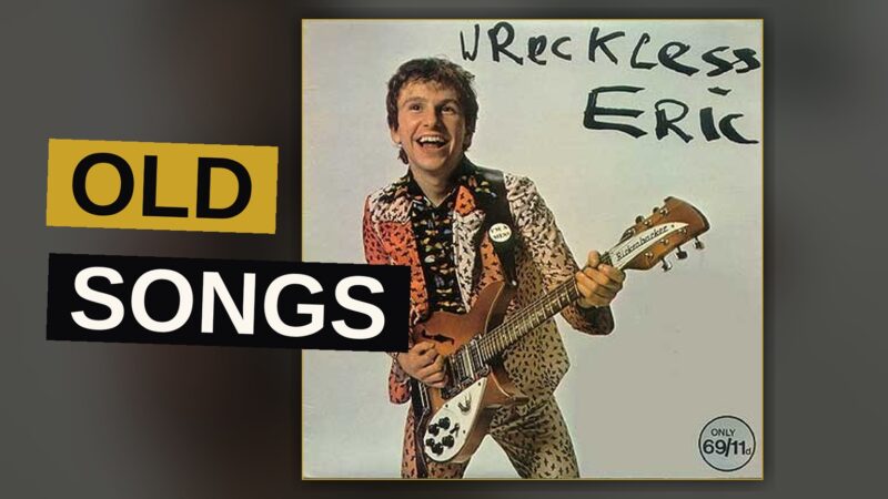 A vinyl record spins beneath warm light, evoking a classic British rock album.